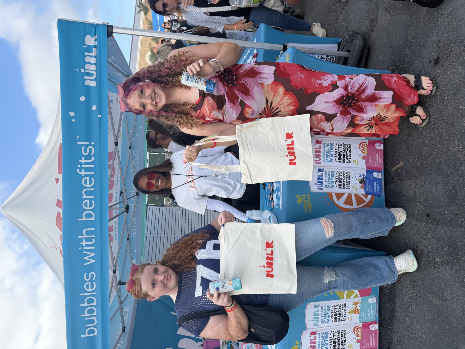 Attendees with BUBBL'R totes at a county fair footprint