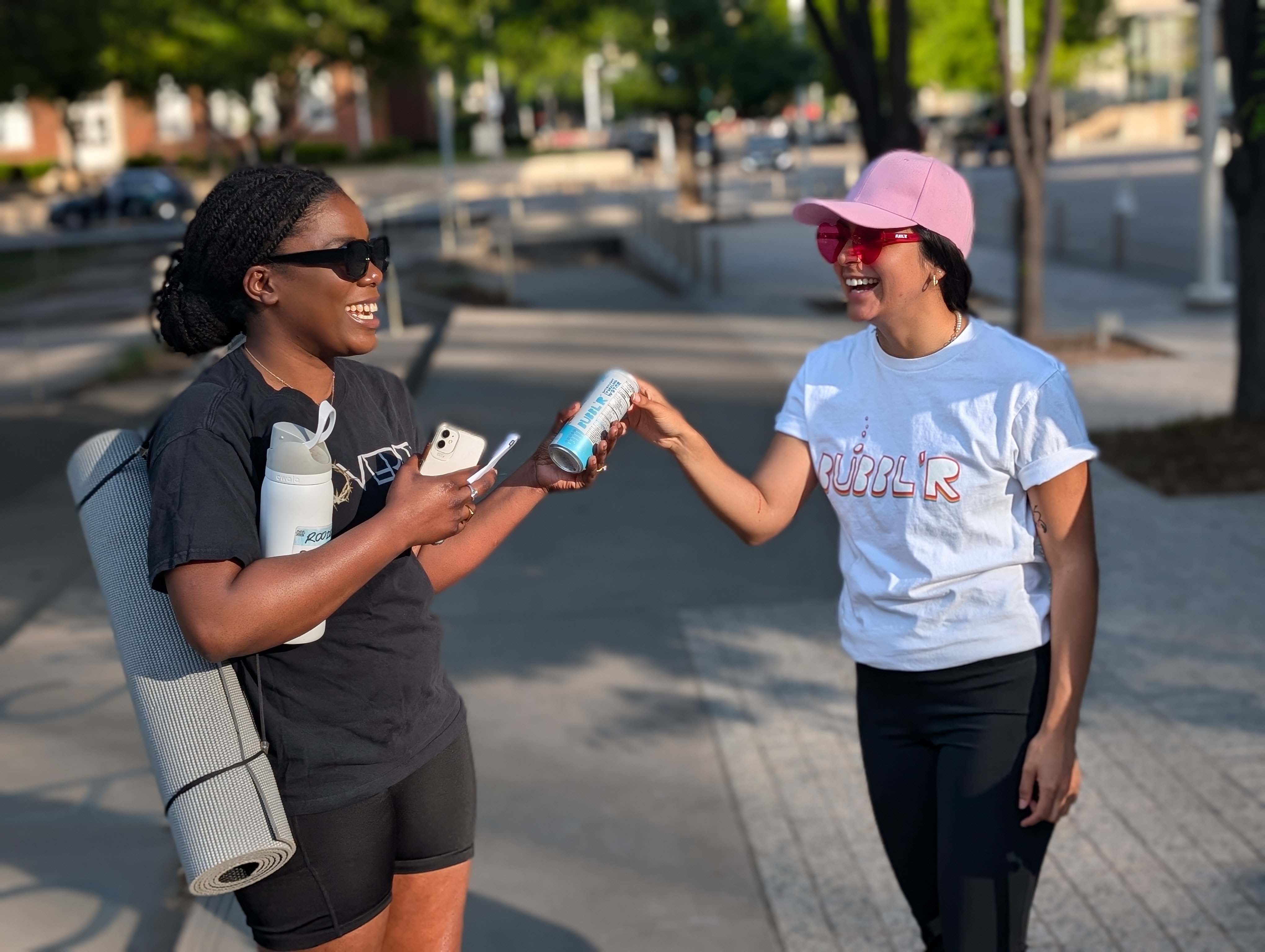 Brand ambassador handing a cold can to a passer-by