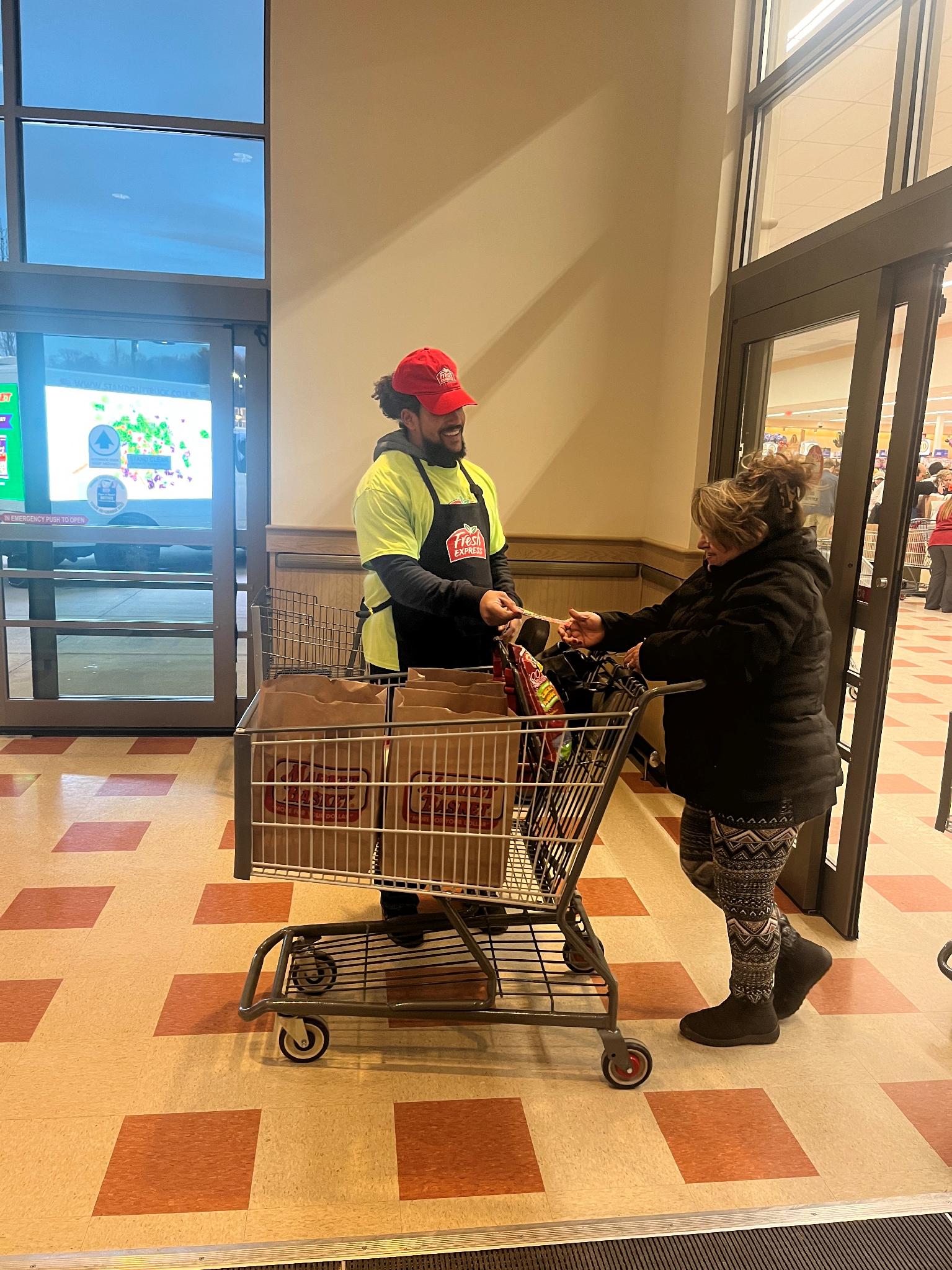 RED, the Kwik Trip mascot, greeting a customer inside a store